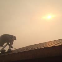 Fixing roof under smoky skies